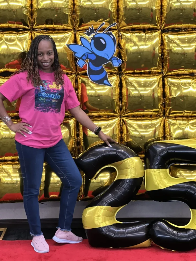 A girl poses beside the event balloon display