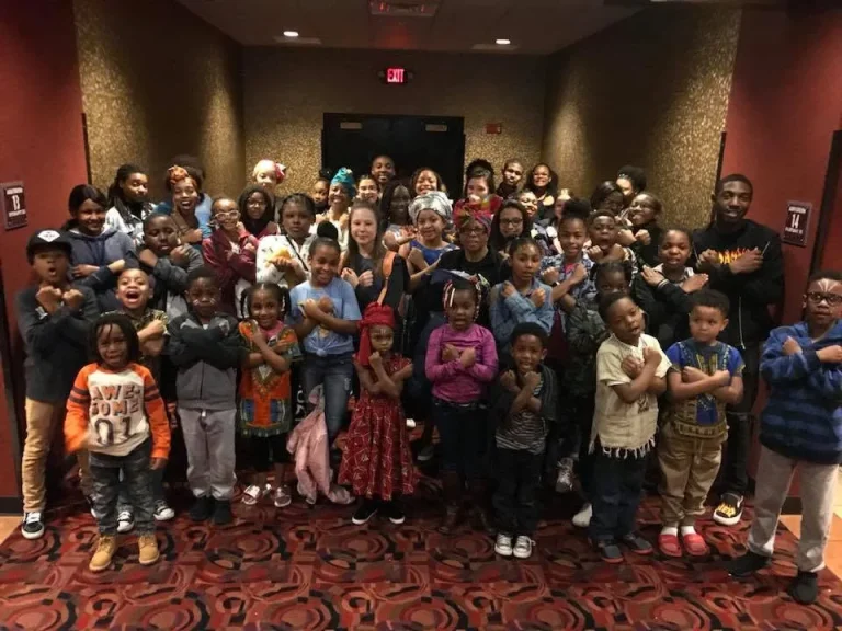 Girls, families and volunteers photographed together