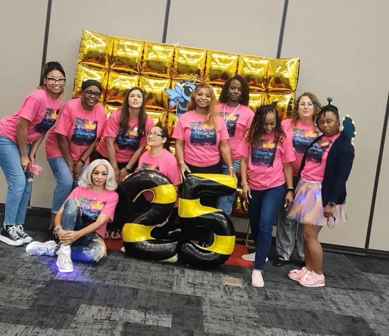 Girls pose together at the event photo wall