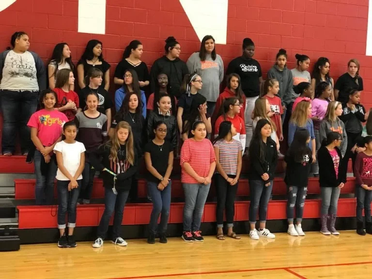 A large group of girls photographed together in a school gym
