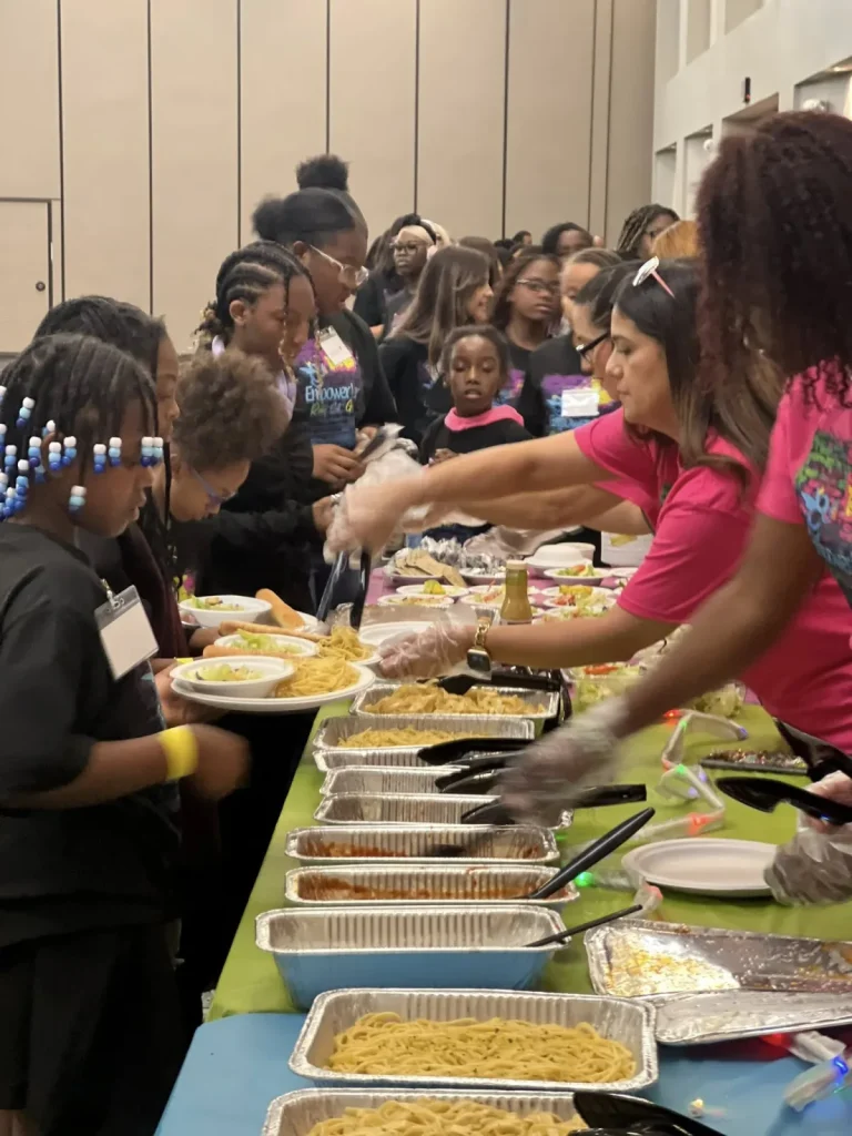 Girls being served lunch at an event