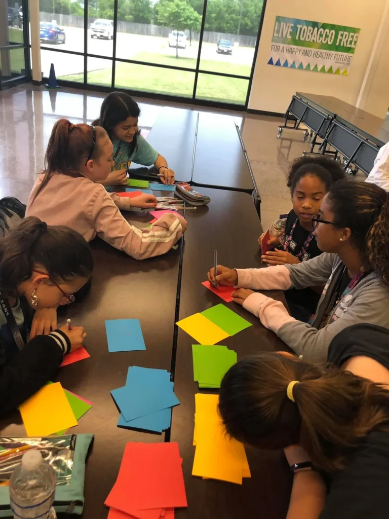 Girls sorting colored paper for an activity