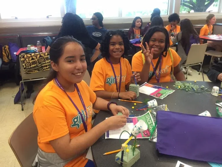 Girls working together at a workshop table