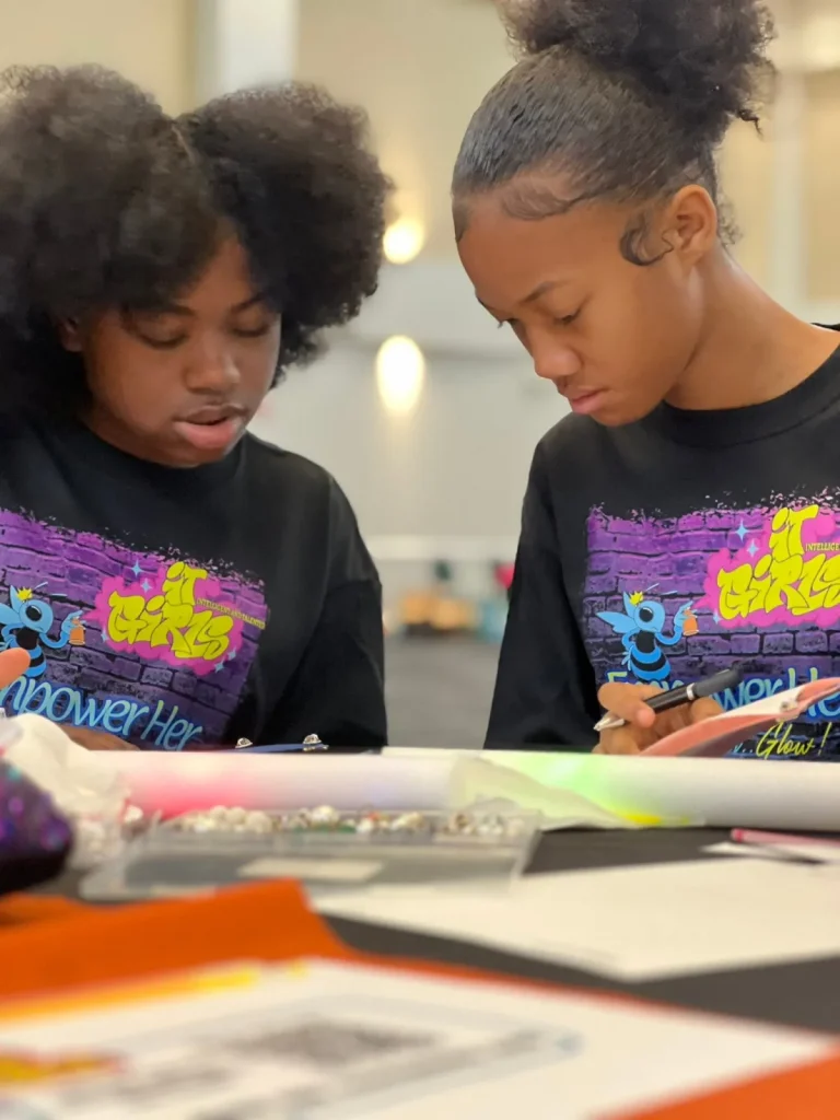 Two girls working through a writing exercise